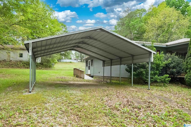 view of vehicle parking with a lawn and a carport