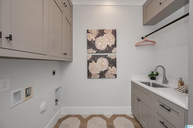 clothes washing area with cabinets, washer hookup, gas dryer hookup, hookup for an electric dryer, and sink