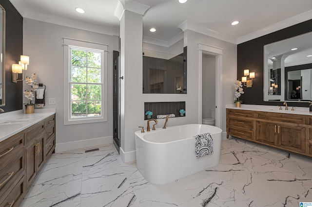 bathroom featuring tile floors, crown molding, a washtub, vanity, and decorative columns