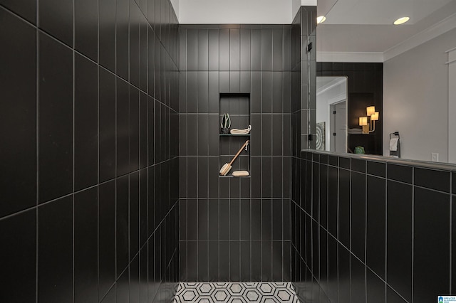 bathroom with ornamental molding, tiled shower, and tile walls