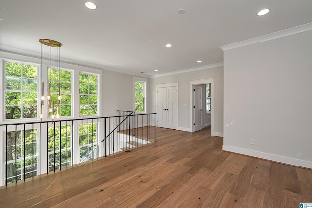 spare room with dark hardwood / wood-style flooring and crown molding