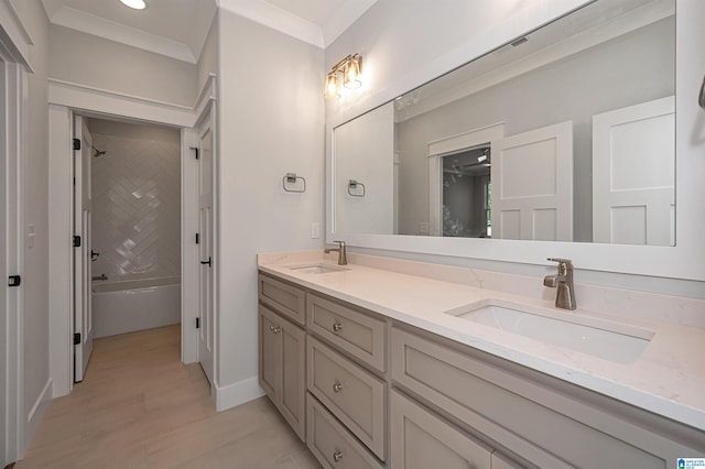 bathroom with dual bowl vanity, ornamental molding, and shower / bathing tub combination