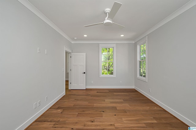 spare room with crown molding, wood-type flooring, and ceiling fan