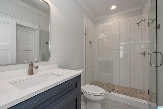 bathroom with a shower with door, vanity with extensive cabinet space, crown molding, and toilet