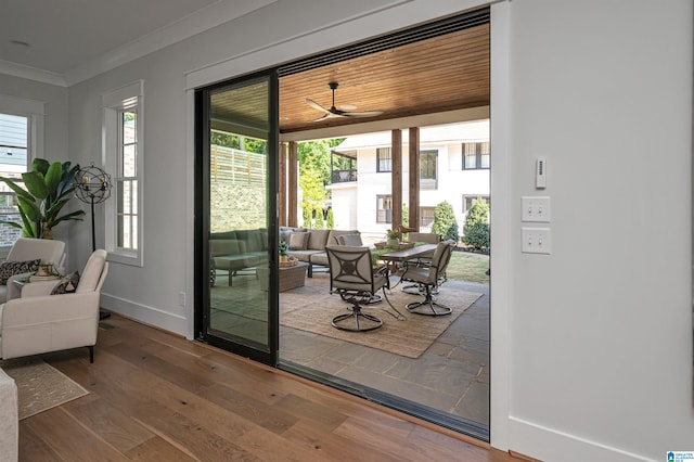 entryway with plenty of natural light, hardwood / wood-style flooring, and crown molding