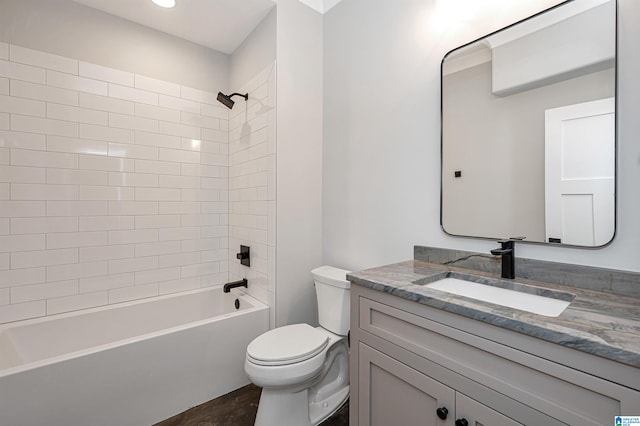 full bathroom with tiled shower / bath, oversized vanity, and toilet