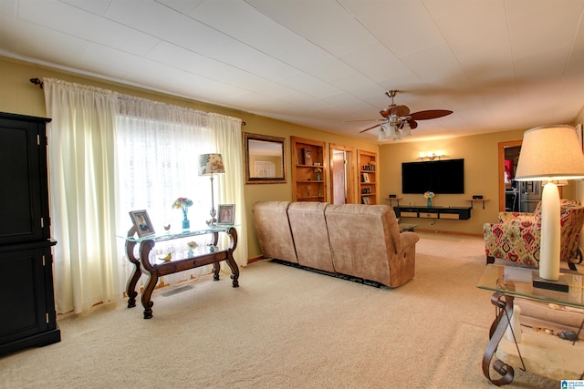 living room with ceiling fan and carpet floors