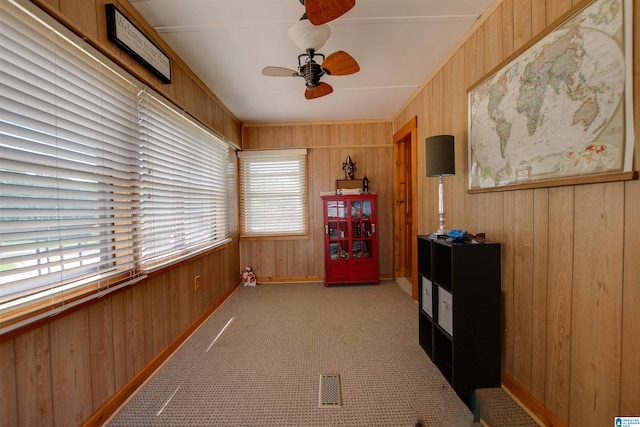 sunroom featuring plenty of natural light and ceiling fan