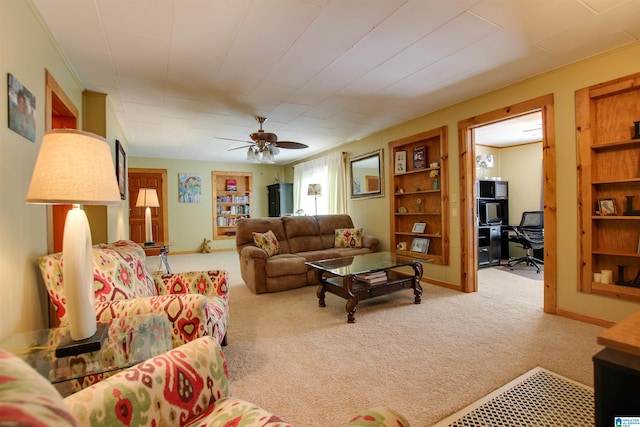 carpeted living room with ceiling fan