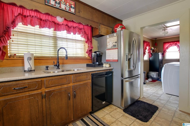 kitchen featuring light tile flooring, dishwasher, washer / clothes dryer, stainless steel fridge, and sink