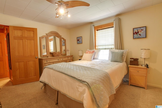 bedroom featuring light colored carpet and ceiling fan