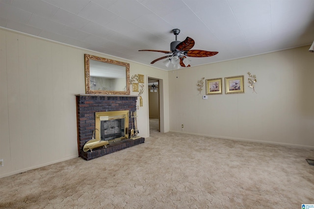 unfurnished living room with carpet floors, ceiling fan, crown molding, and a brick fireplace