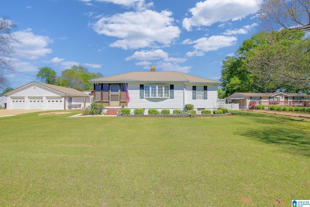 view of front of home with a front lawn, an outdoor structure, and a garage