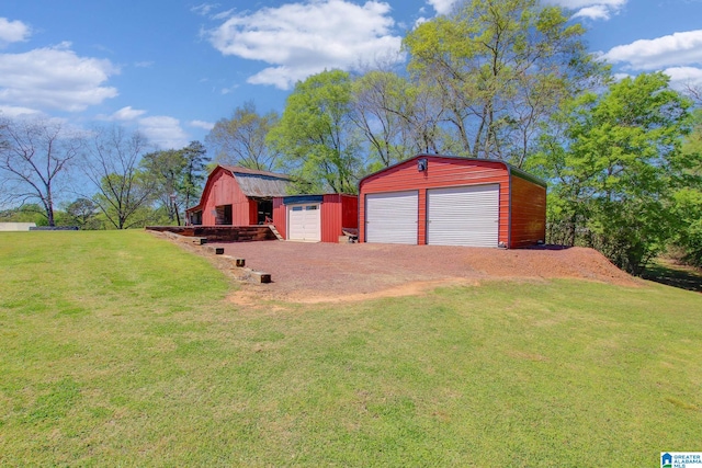 view of yard with a garage and an outdoor structure