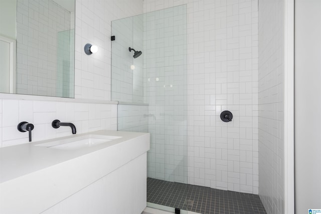 bathroom with backsplash, vanity, and tiled shower