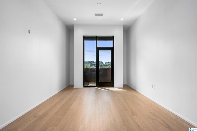 empty room with light hardwood / wood-style flooring