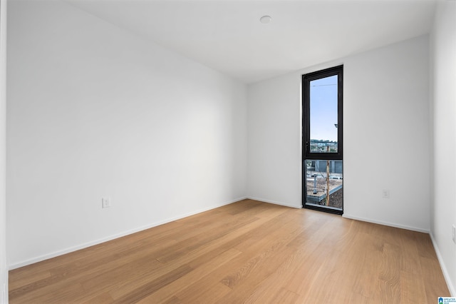 unfurnished room featuring light hardwood / wood-style floors