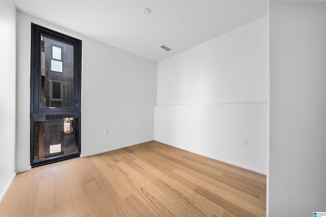 empty room with light hardwood / wood-style floors