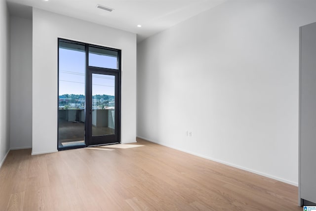 spare room with light hardwood / wood-style floors