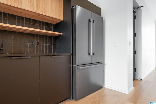 kitchen featuring decorative backsplash, light hardwood / wood-style floors, and high end refrigerator