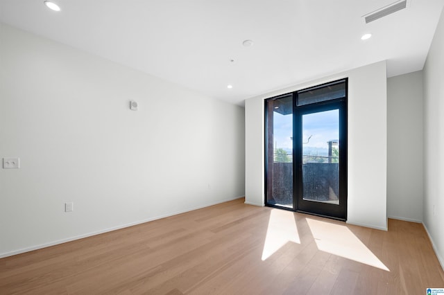 unfurnished room with light hardwood / wood-style floors