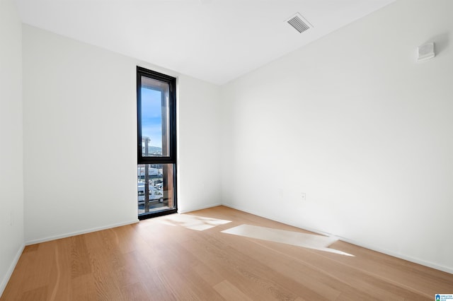 spare room with light hardwood / wood-style flooring