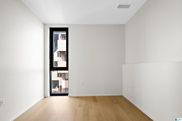 unfurnished room featuring light hardwood / wood-style floors