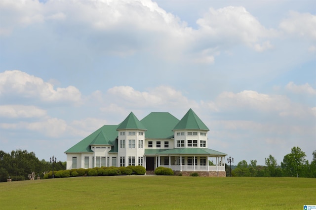 victorian-style house with a front lawn