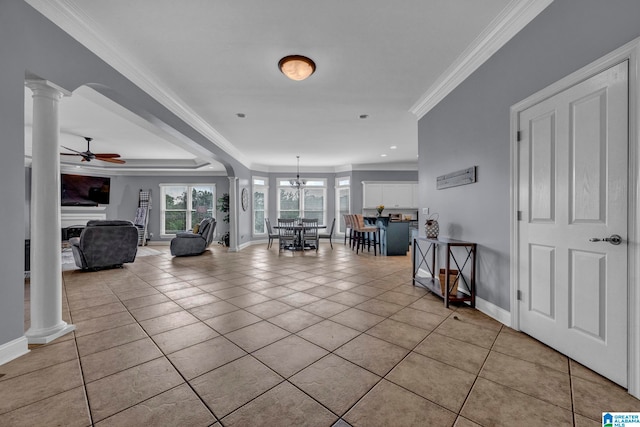 entryway featuring ceiling fan, crown molding, light tile floors, and decorative columns