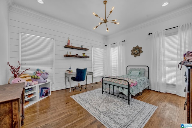 bedroom featuring light hardwood / wood-style flooring and crown molding