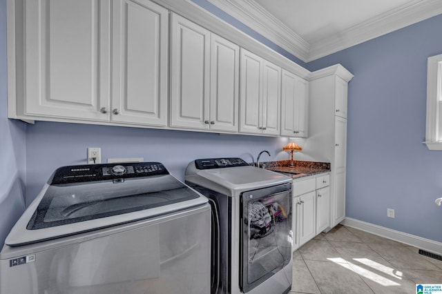 washroom featuring cabinets, washer and dryer, sink, light tile floors, and ornamental molding