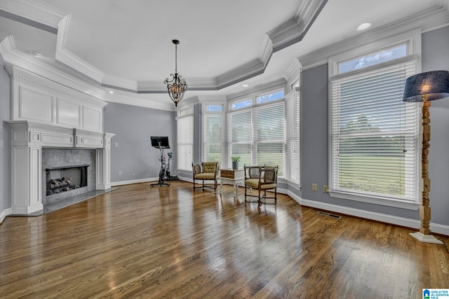 sitting room featuring hardwood / wood-style floors, a raised ceiling, and a wealth of natural light