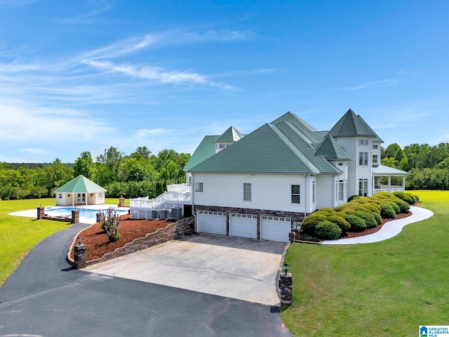 view of front of property featuring a garage and a front lawn