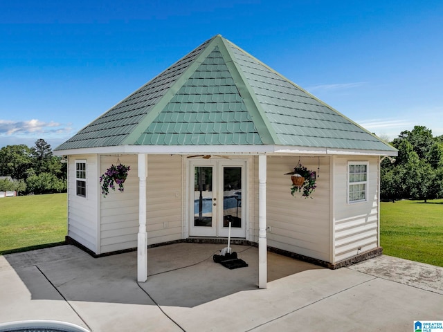 exterior space with french doors and a lawn