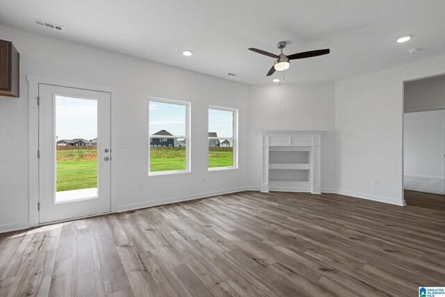 unfurnished living room with light wood-style floors, a fireplace, visible vents, and recessed lighting