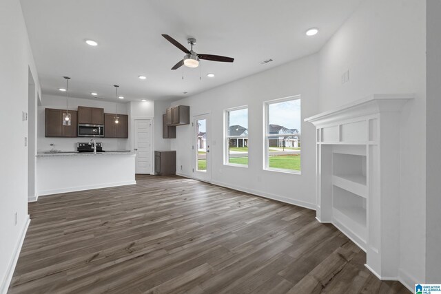 unfurnished living room featuring recessed lighting, dark wood-style flooring, ceiling fan, and baseboards