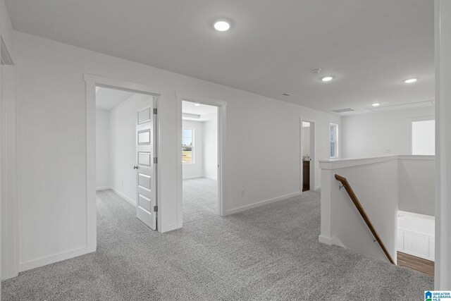 unfurnished room featuring baseboards, recessed lighting, and light colored carpet