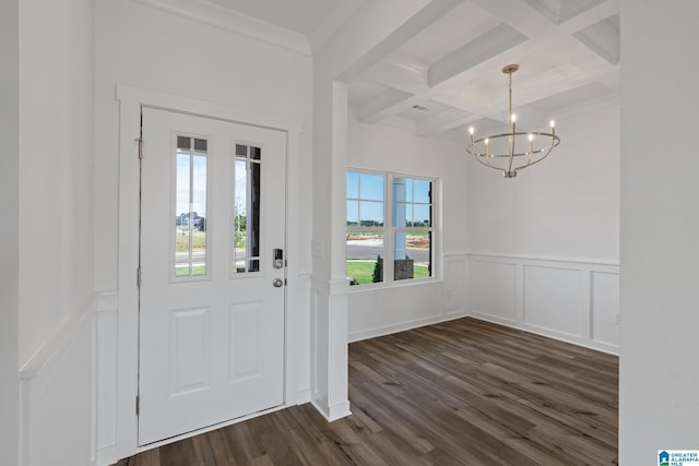 foyer entrance with coffered ceiling, ornamental molding, wainscoting, dark wood-style floors, and beamed ceiling