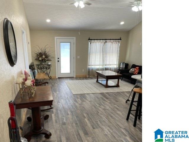 living room with ceiling fan and hardwood / wood-style flooring