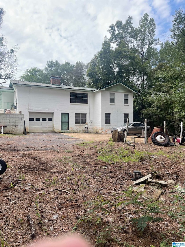 rear view of house featuring a garage