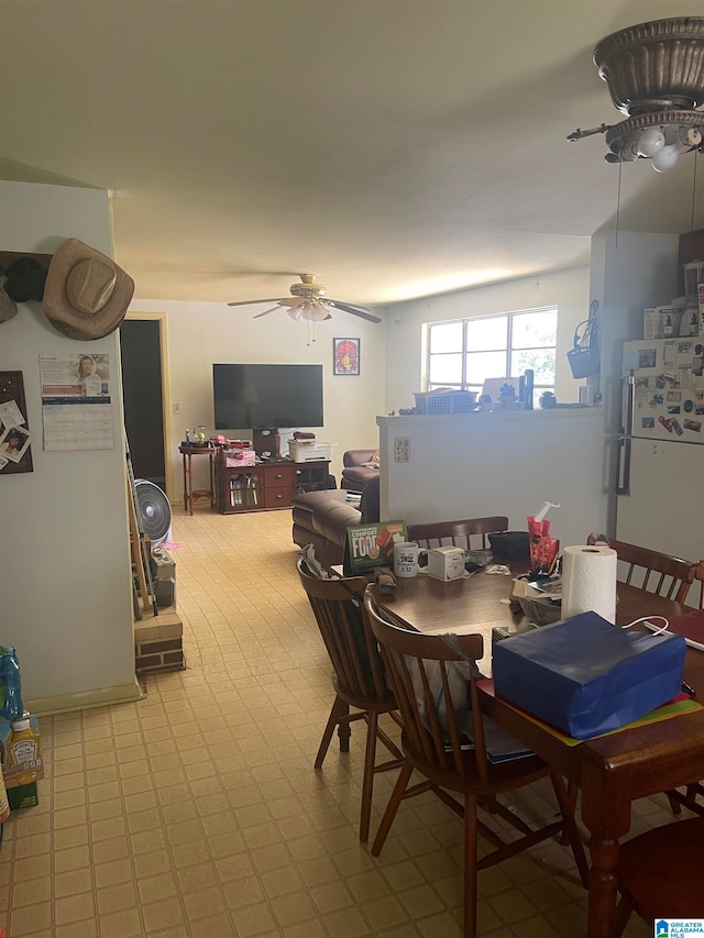 tiled dining room featuring ceiling fan