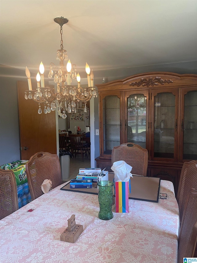 carpeted dining space with a chandelier