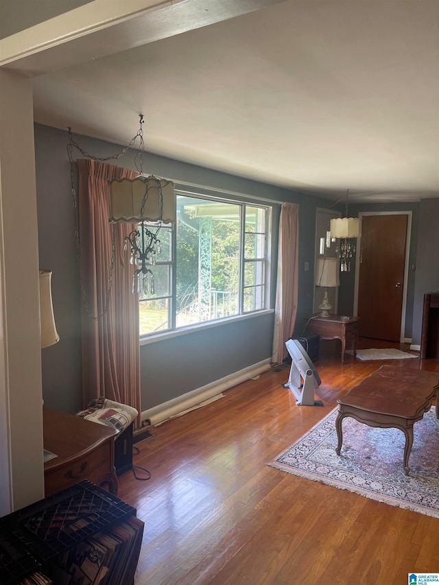 living room featuring wood-type flooring and an inviting chandelier