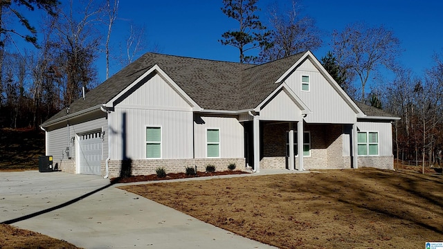 view of front of house with a garage and central AC