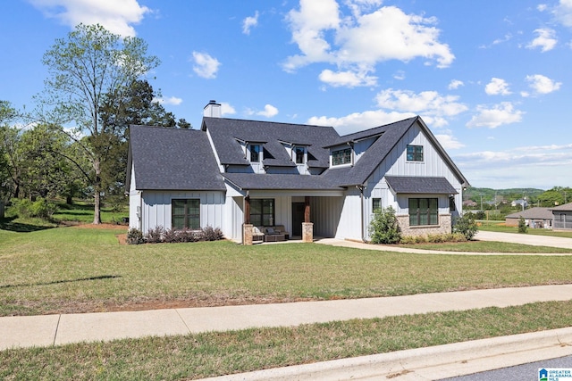 modern inspired farmhouse featuring a front lawn