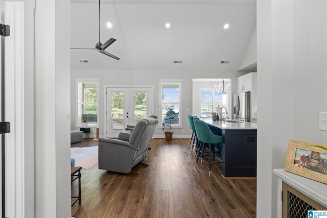 living room featuring plenty of natural light, dark hardwood / wood-style flooring, and high vaulted ceiling