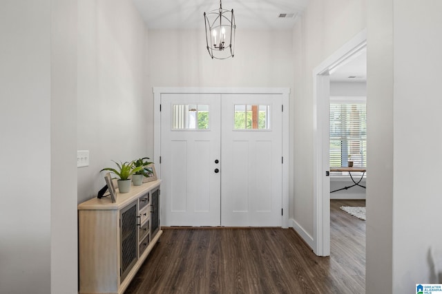 entryway featuring dark hardwood / wood-style floors and a notable chandelier