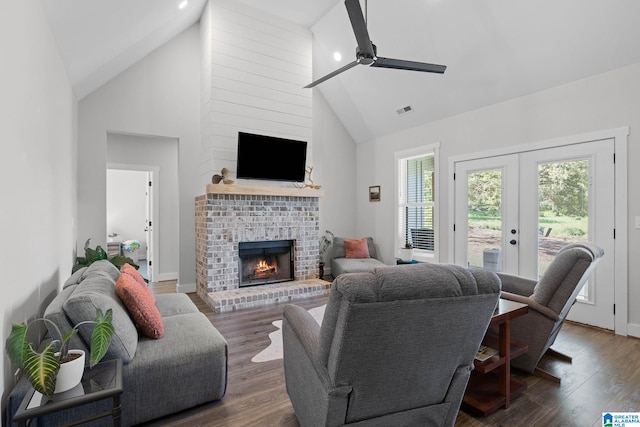 living room featuring a healthy amount of sunlight, dark hardwood / wood-style flooring, and high vaulted ceiling