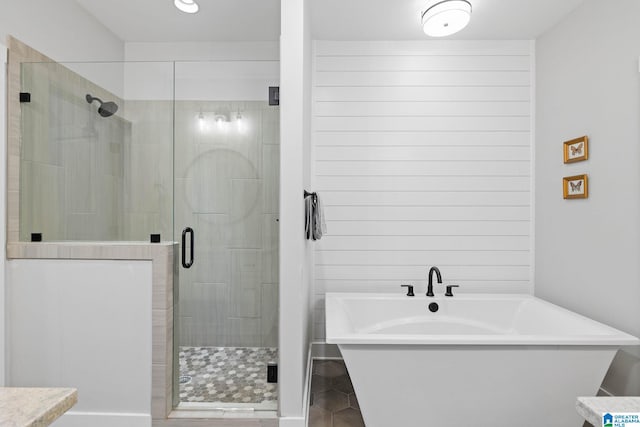 bathroom featuring separate shower and tub