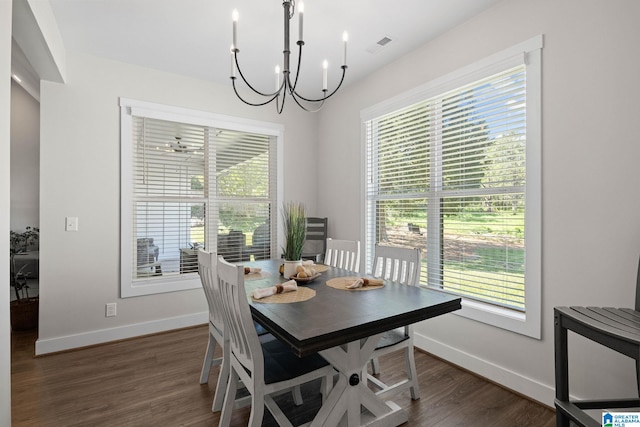 dining room featuring dark hardwood / wood-style flooring and an inviting chandelier